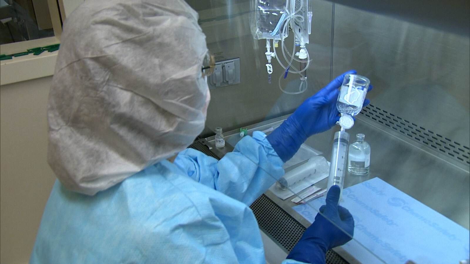 Pharmacist performing sterile compounding of an IV product in a clean room